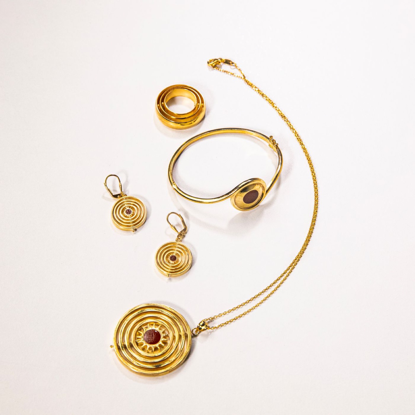 Gold earrings, a bangle and a round pendant