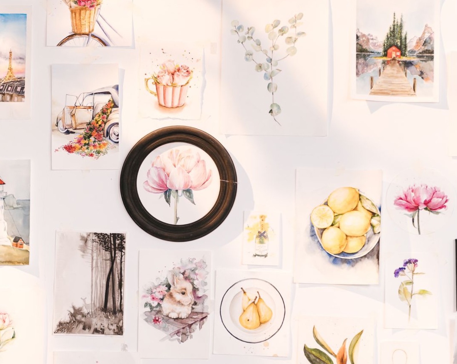 A wall of small floral and landscape illustrations